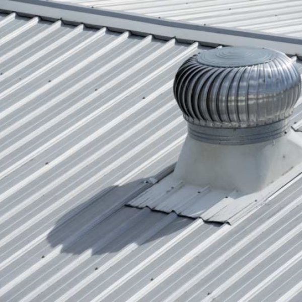 Stainless steel exhaust fan on factory roof.